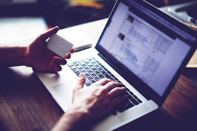 Cropped Shot Of A Man's Hands Using A Laptop